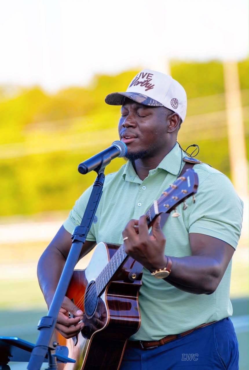 Joel Kisakye leading worship