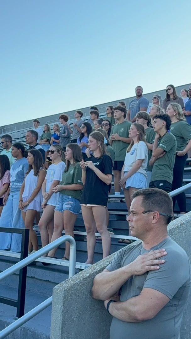 Crowd standing together at dusk